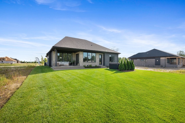 rear view of house with a yard