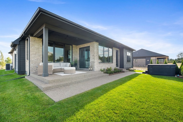 back of property featuring a yard, cooling unit, a patio, and a hot tub