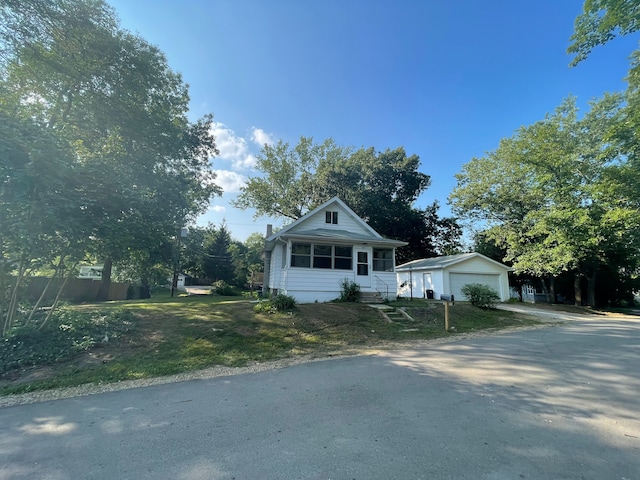 view of front facade featuring an outbuilding and a garage