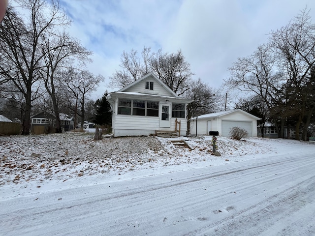 view of front of property with a garage and an outdoor structure