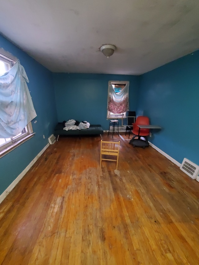 unfurnished room with hardwood / wood-style flooring