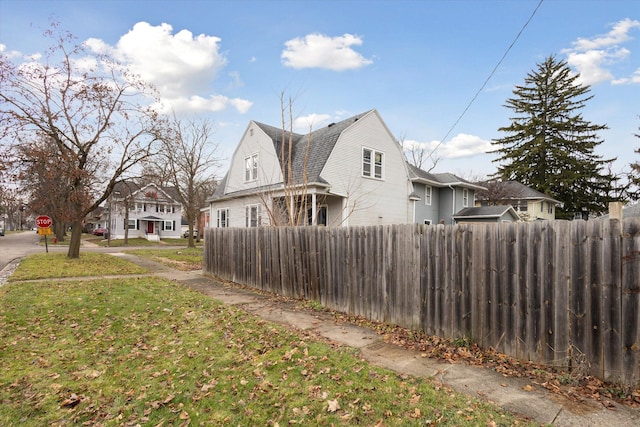 view of side of home featuring a yard