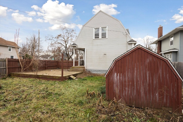 rear view of property with a lawn and a wooden deck