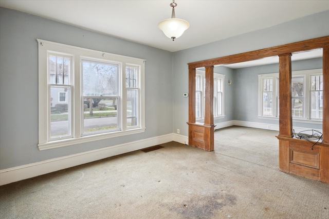 interior space with ornate columns and carpet