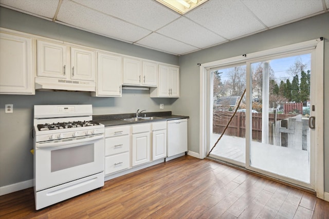 kitchen with hardwood / wood-style floors, a paneled ceiling, and white appliances