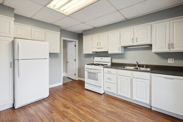 kitchen with sink, white cabinets, dark wood-type flooring, and white appliances