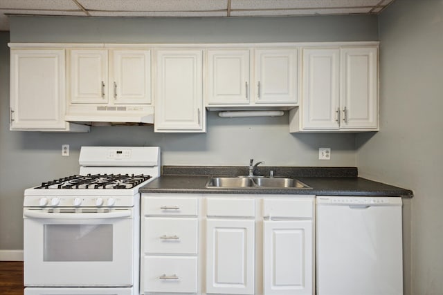 kitchen featuring white cabinetry, sink, a drop ceiling, and white appliances