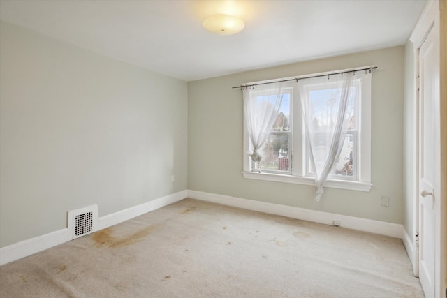 unfurnished room with light carpet