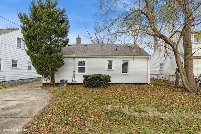 rear view of house featuring central air condition unit