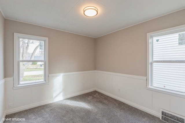 carpeted spare room with ornamental molding