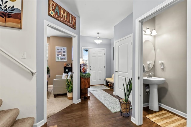 entrance foyer with dark hardwood / wood-style floors and sink