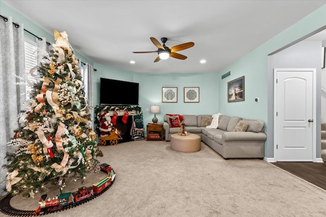 living room with hardwood / wood-style flooring and ceiling fan