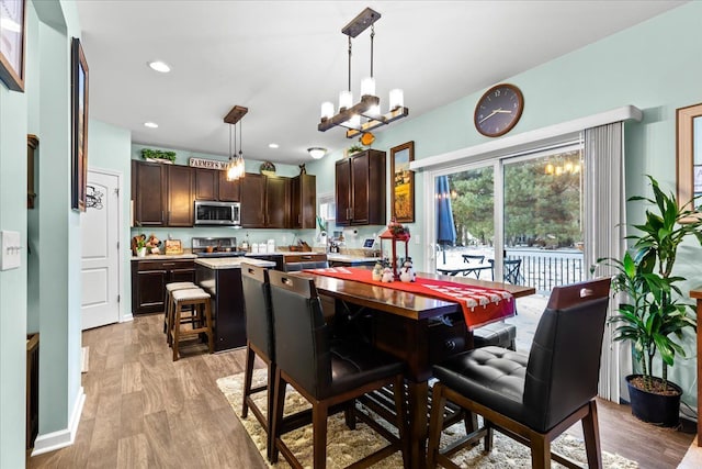 dining room with a chandelier and light hardwood / wood-style flooring