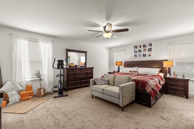 bedroom featuring ceiling fan and light carpet