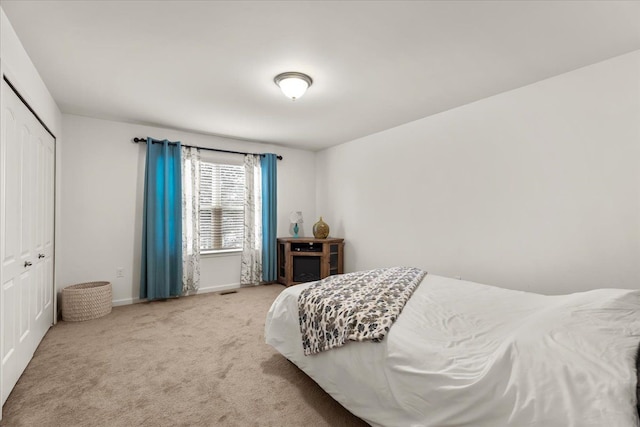 carpeted bedroom with a closet