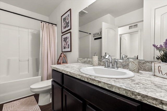 full bathroom featuring vanity, toilet, wood-type flooring, and shower / tub combo