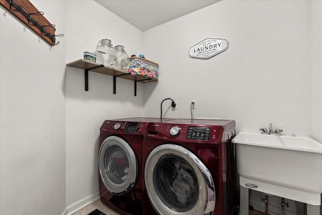 clothes washing area featuring sink and washing machine and clothes dryer