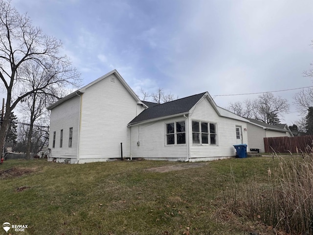 rear view of property with a yard