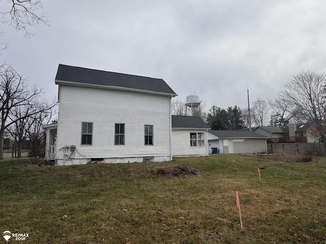 rear view of property with a lawn