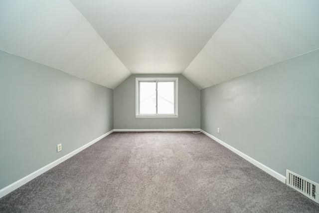 bonus room featuring lofted ceiling and carpet floors