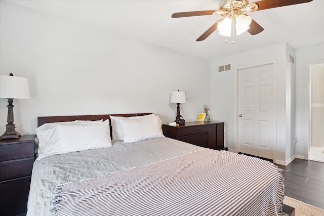 bedroom with dark wood-style floors, ceiling fan, visible vents, and baseboards