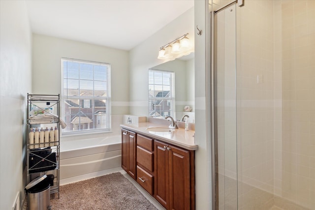 full bathroom featuring vanity, a shower stall, and a bath