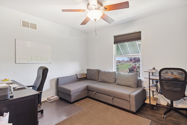 home office with dark wood-style floors, baseboards, visible vents, and a ceiling fan