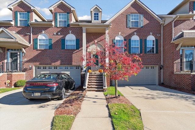 view of property with a garage, concrete driveway, and brick siding