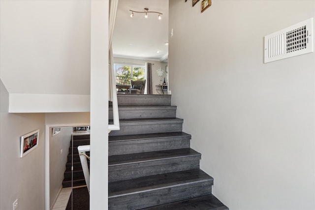 stairway featuring tile patterned flooring and visible vents