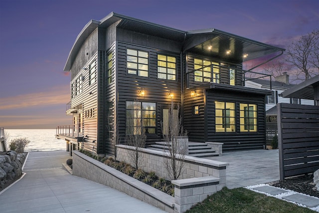 exterior space with a balcony and a water view