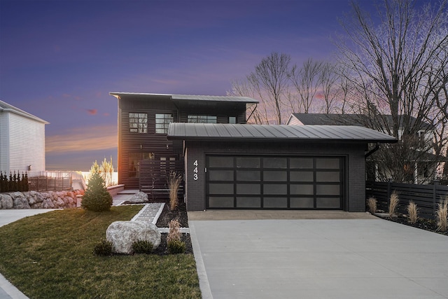 contemporary home with a lawn and a garage