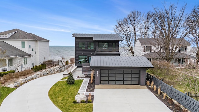 view of front facade with a water view and a garage