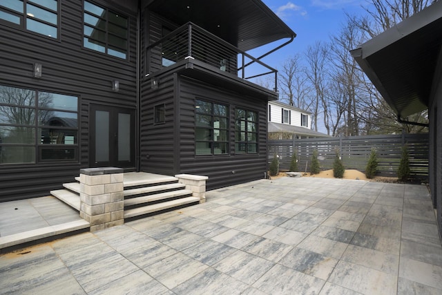 view of patio featuring a balcony and french doors