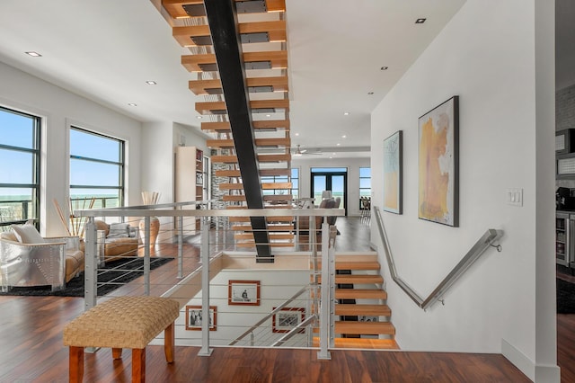 stairs with wood-type flooring and wine cooler