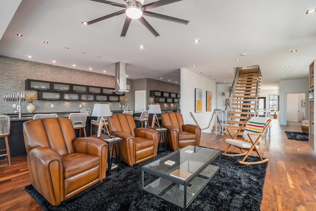 living room with ceiling fan and wood-type flooring