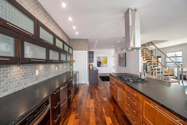 kitchen with backsplash, dark hardwood / wood-style floors, gas stovetop, and island exhaust hood