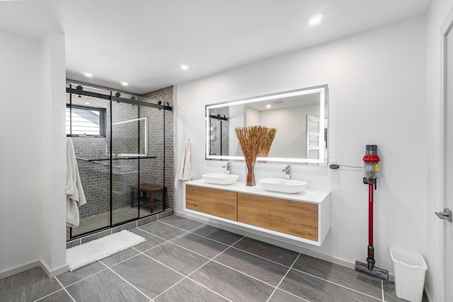 bathroom with tile patterned flooring, vanity, and a shower with door