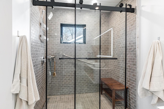 bathroom featuring a shower with shower door