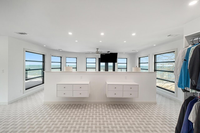 bathroom featuring ceiling fan and a water view