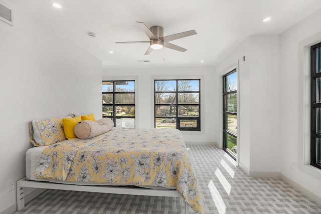 bedroom with ceiling fan and light carpet