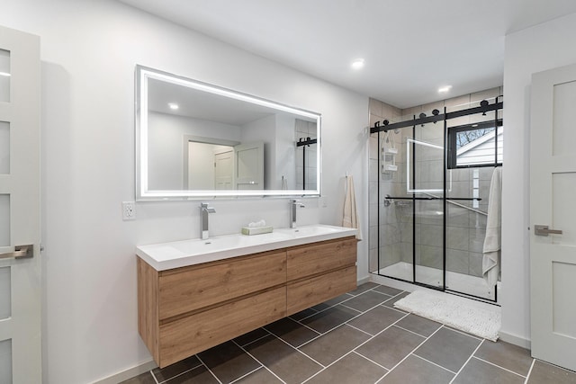 bathroom featuring tile patterned floors, vanity, and a shower with shower door