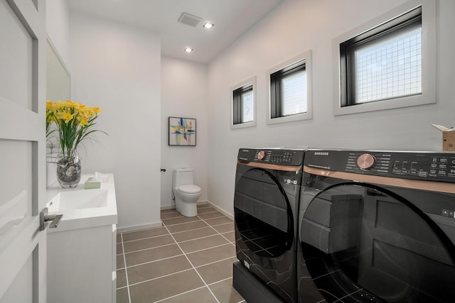 bathroom featuring washing machine and dryer, tile patterned flooring, vanity, and toilet