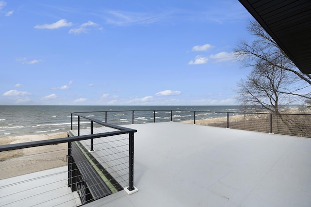 exterior space featuring a beach view and a water view