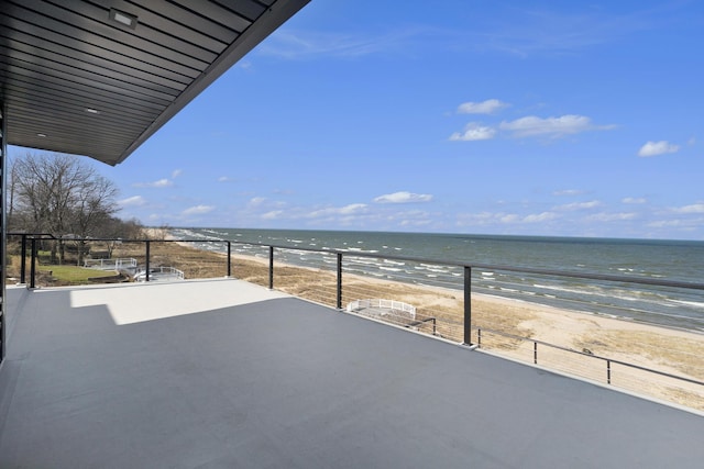 balcony featuring a water view and a view of the beach