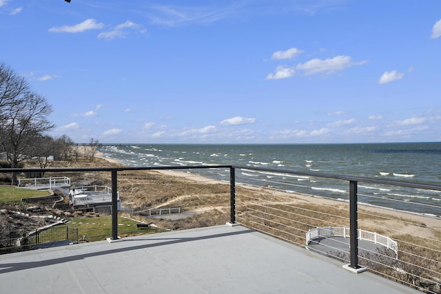 balcony featuring a water view and a beach view