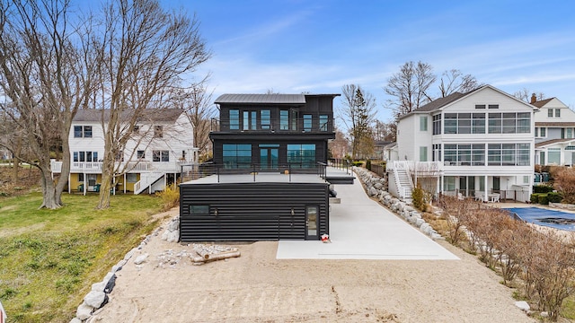 view of front of home featuring a balcony and a front lawn