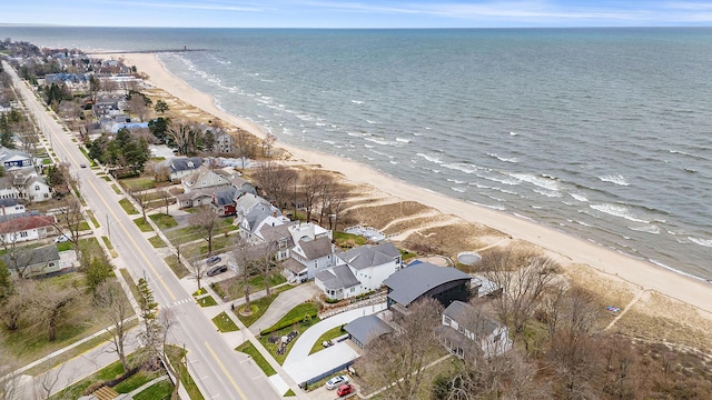 birds eye view of property featuring a water view and a beach view