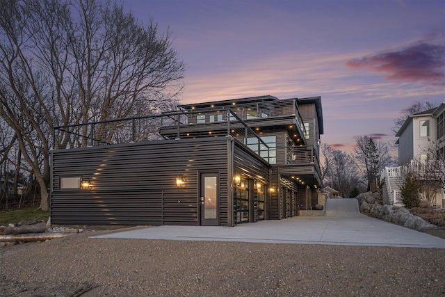 contemporary home with a patio area and a balcony