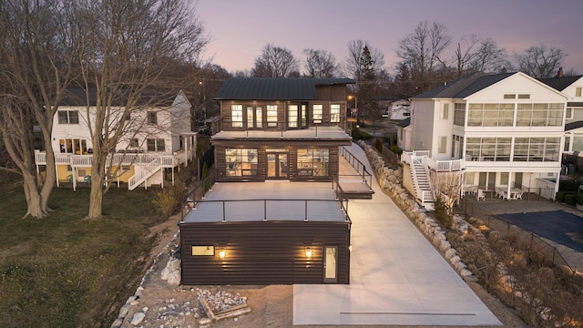 back house at dusk with a balcony