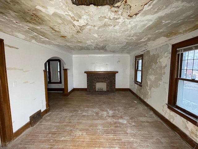 unfurnished living room featuring hardwood / wood-style floors and a fireplace